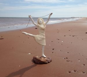 sculpture of woman on a beach